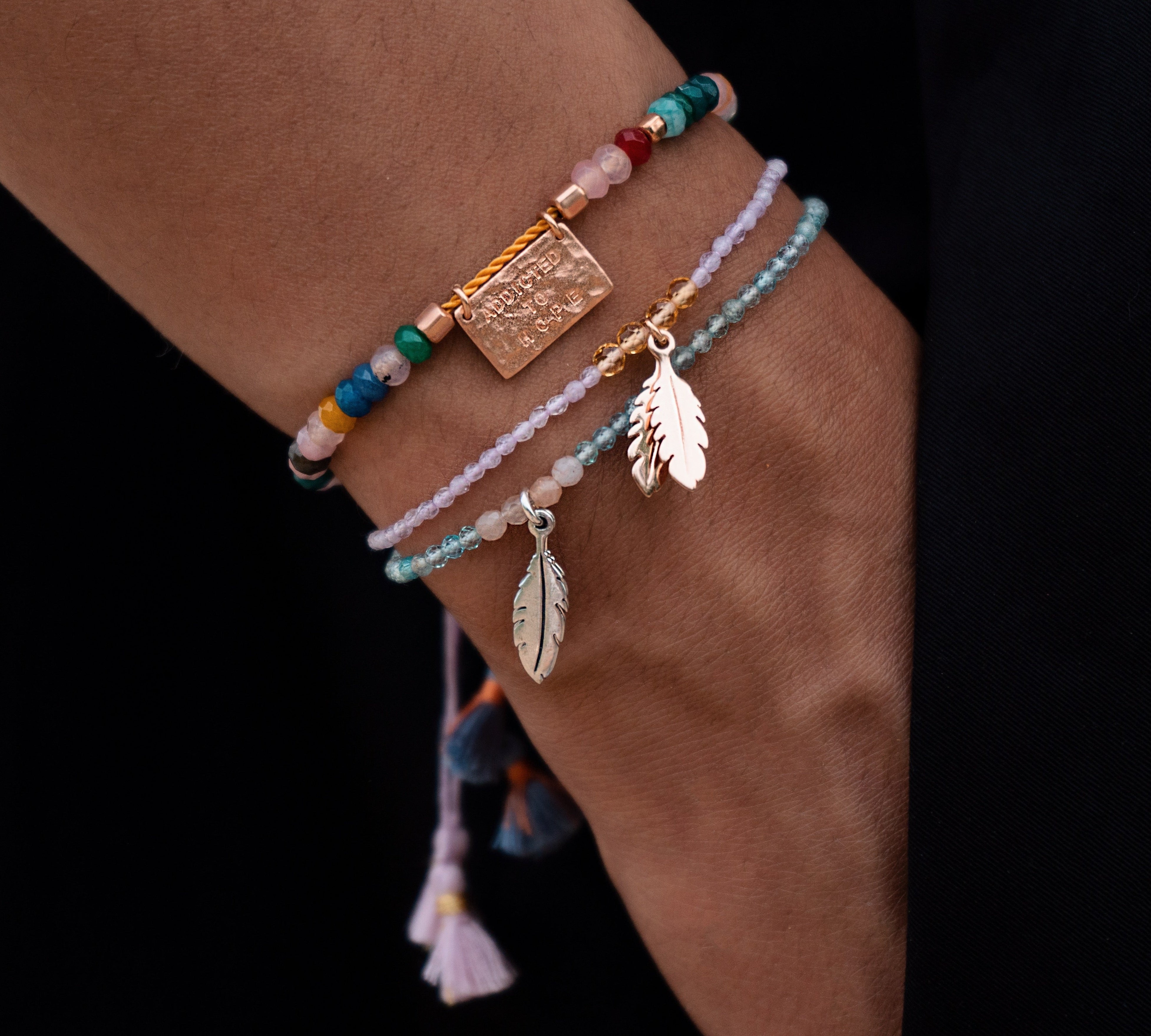 Lila-gelbes Edelstein Armband soul wings mit echten Steinen und vergoldeten Feder Anhängern.